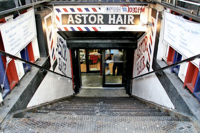 Stairs lead down to the basement entrance to Astor Hair.